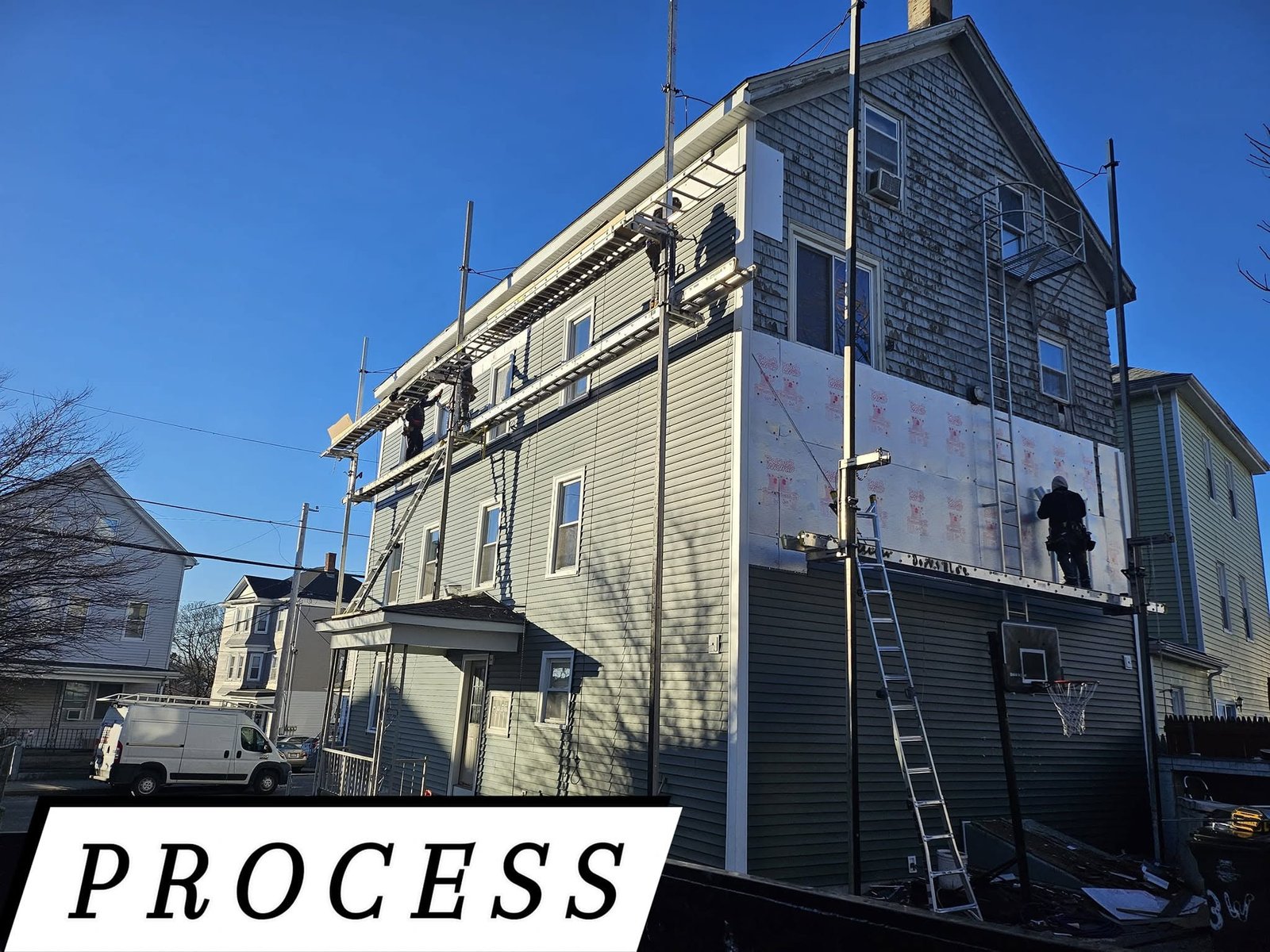 Projects Siding replacement in progress on a multi-family home in Massachusetts